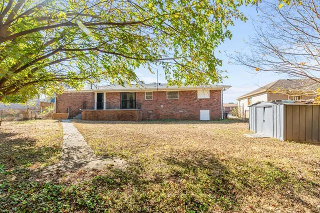 a front view of house with a garden