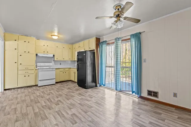 a kitchen with stainless steel appliances a refrigerator sink and cabinets