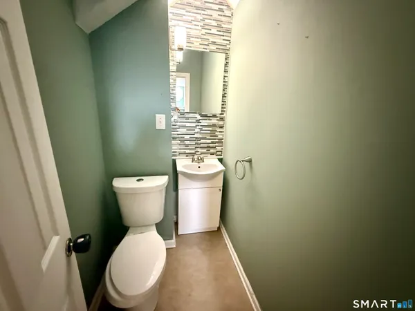 a white toilet sitting next to a sink