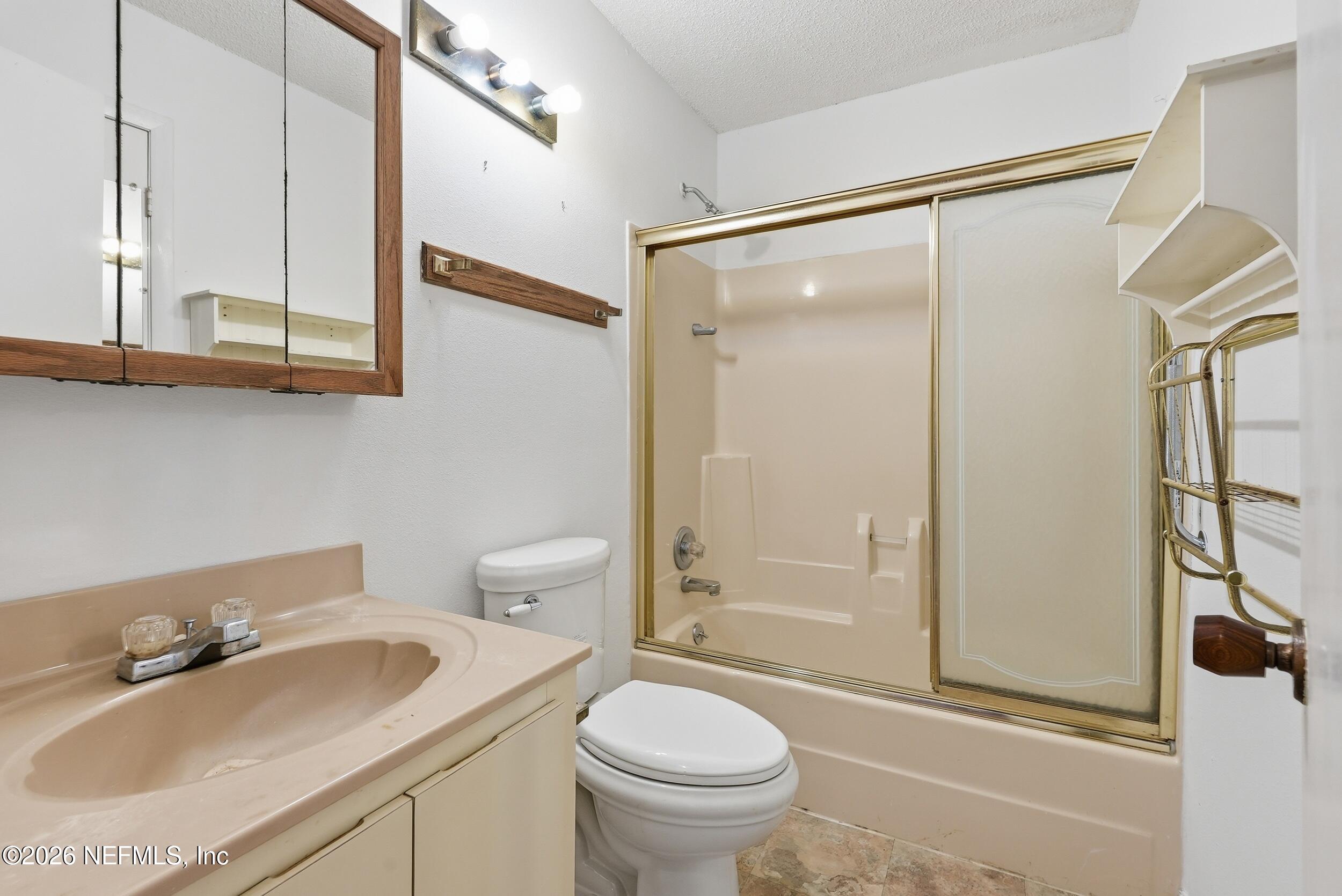 7593 Silver Sands Road Keystone Heights, FL 32656 - Photo 18 of 36 a bathroom with a sink toilet and shower