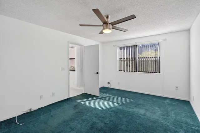a bathroom with a granite countertop sink mirror and shower