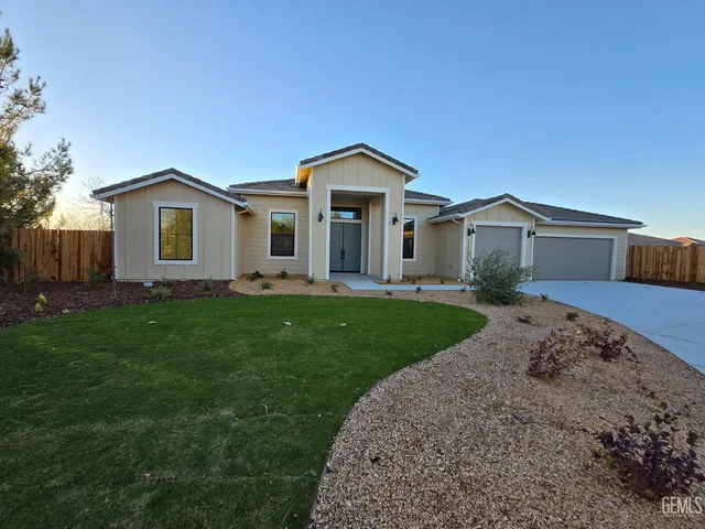 a view of a house with a small yard and a large window