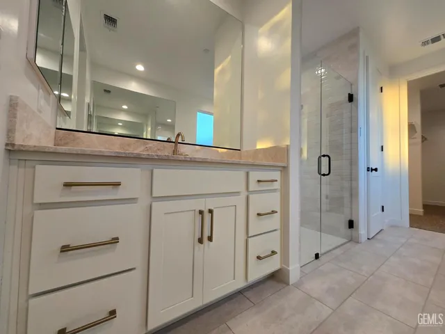 a bathroom with a shower and a sink