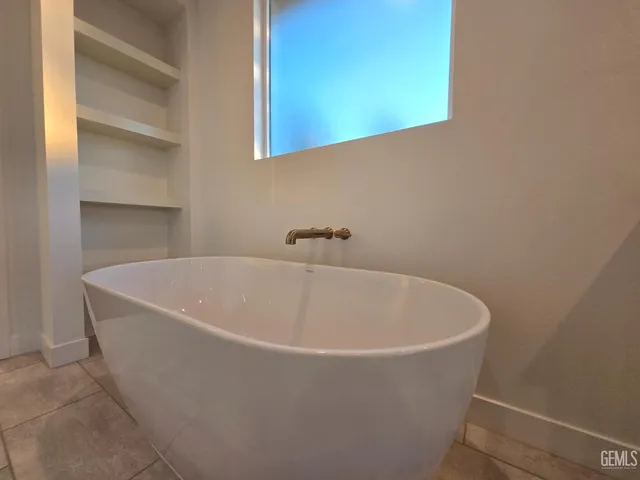 a white bath tub sitting in a bathroom