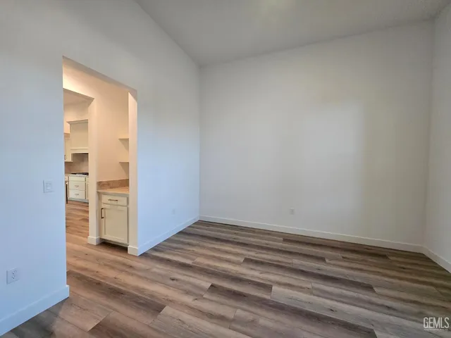 a view of wooden floor and closet in a room