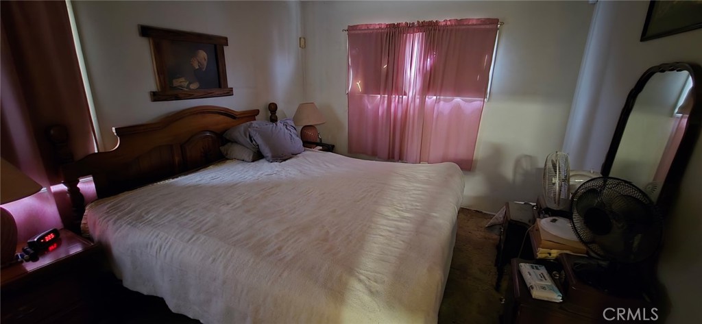 11826 Studebaker Road Norwalk, CA 90650 - Photo 15 of 15 a bed sitting in a bedroom next to a window