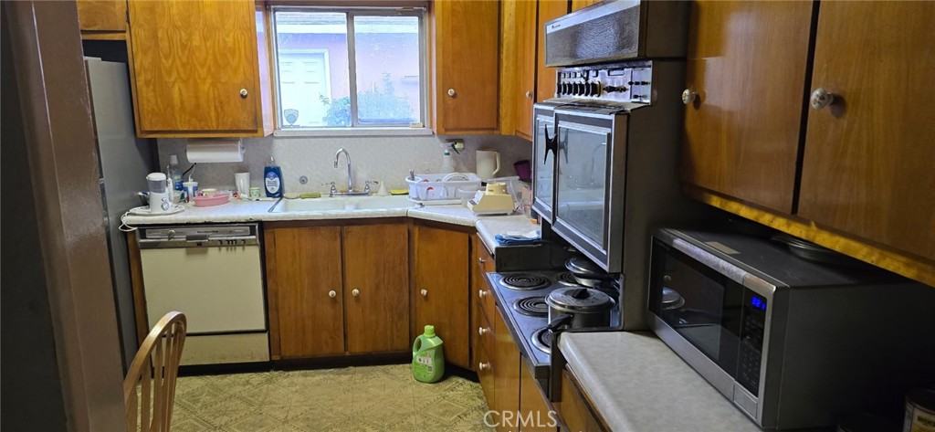 11826 Studebaker Road Norwalk, CA 90650 - Photo 10 of 15 a view of a kitchen with fridge and wooden floor