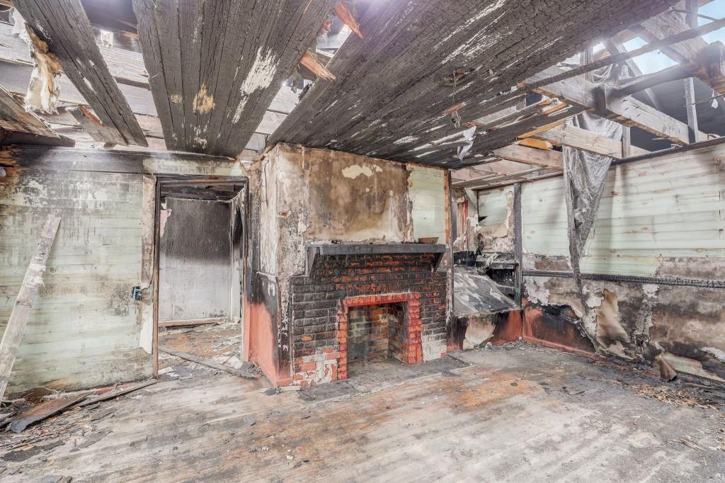 2636 Old Toney Road Ellenwood, GA 30294 - Photo 14 of 16 a view of an empty room with wooden floor and a fireplace