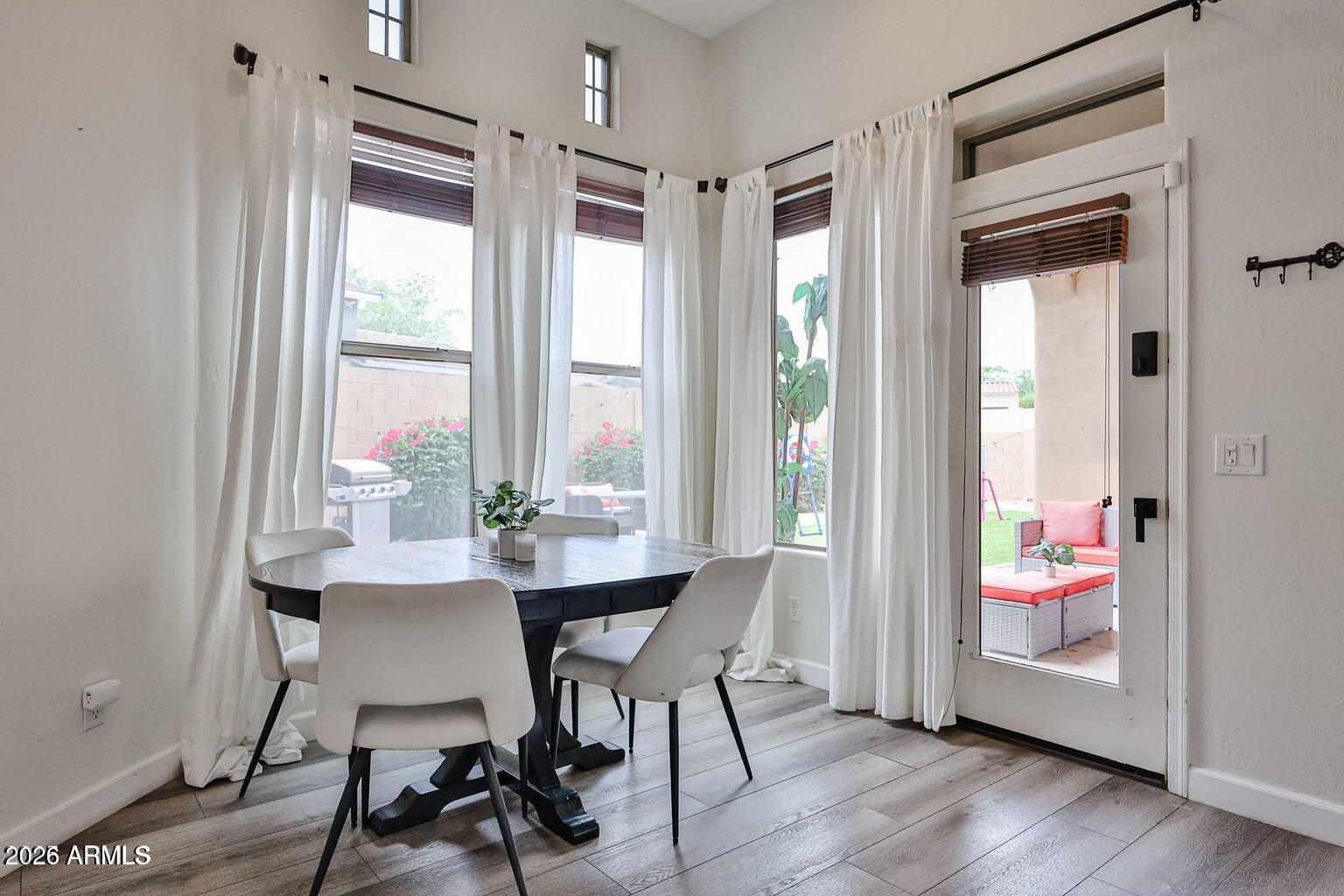 3950 North Edith Way Buckeye, AZ 85396 - Photo 12 of 32 a view of a dining room with furniture window and wooden floor