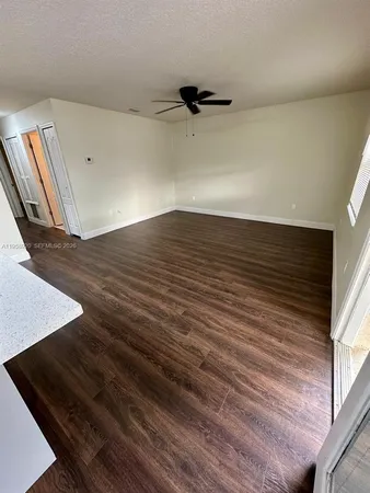 a view of a room with wooden floor