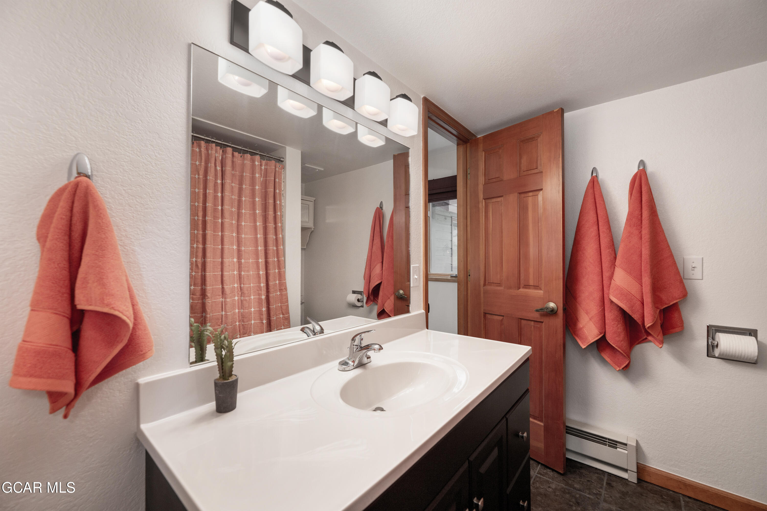 820 Wolverine Lane, Unit 3 Fraser, CO 80442 - Photo 28 of 43 a bathroom with a sink vanity and a mirror