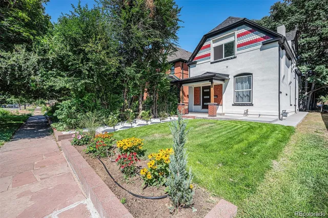 a view of house with a yard and garden