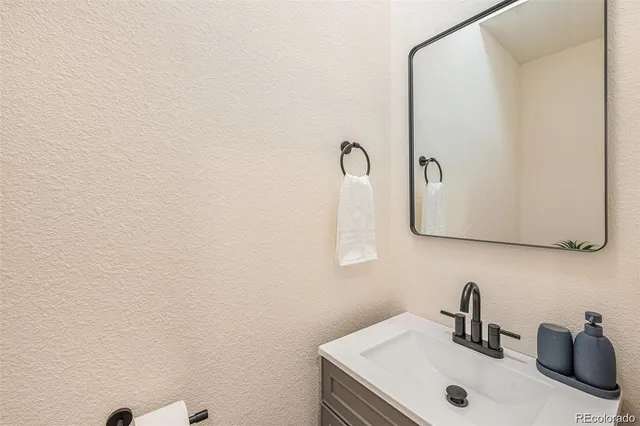 a bathroom with a sink and mirror