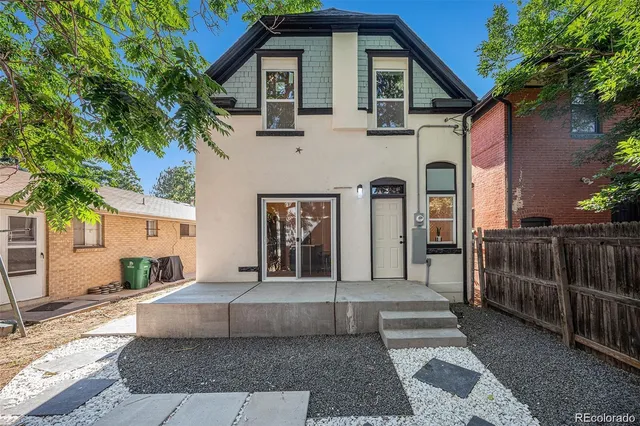 a front view of a house with glass windows and yard