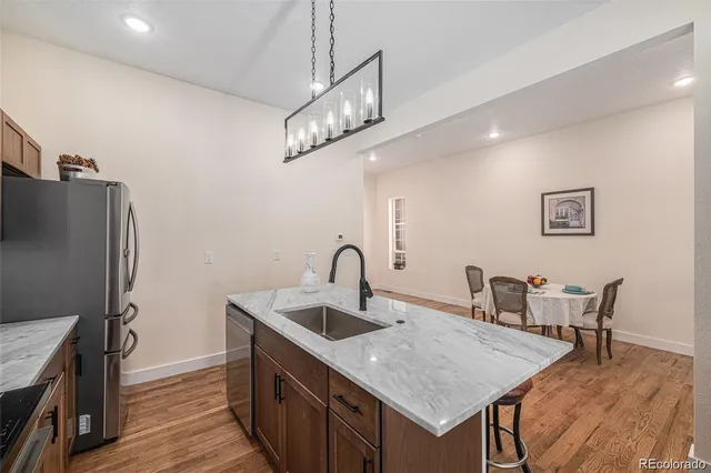a kitchen with sink and refrigerator