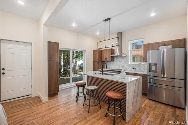 a kitchen with wooden floors and appliances
