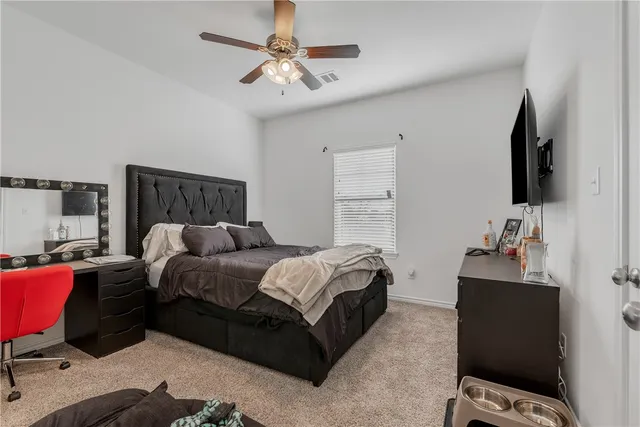 a bed room with a bed window and a chair