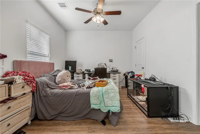 a bedroom with furniture and a wooden floor