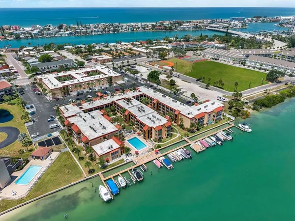 an aerial view of residential houses with outdoor space and river