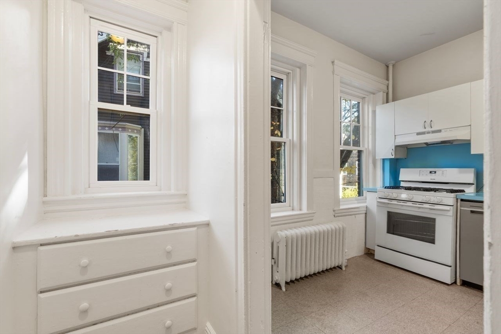 441 Washington Street, Unit 2 Brookline, MA 02446 - Photo 12 of 28 a kitchen with a stove and a white cabinet
