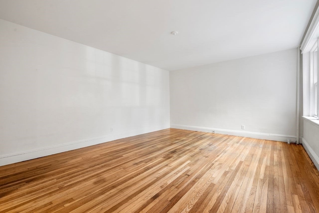 441 Washington Street, Unit 2 Brookline, MA 02446 - Photo 14 of 28 a view of an empty room and wooden floor
