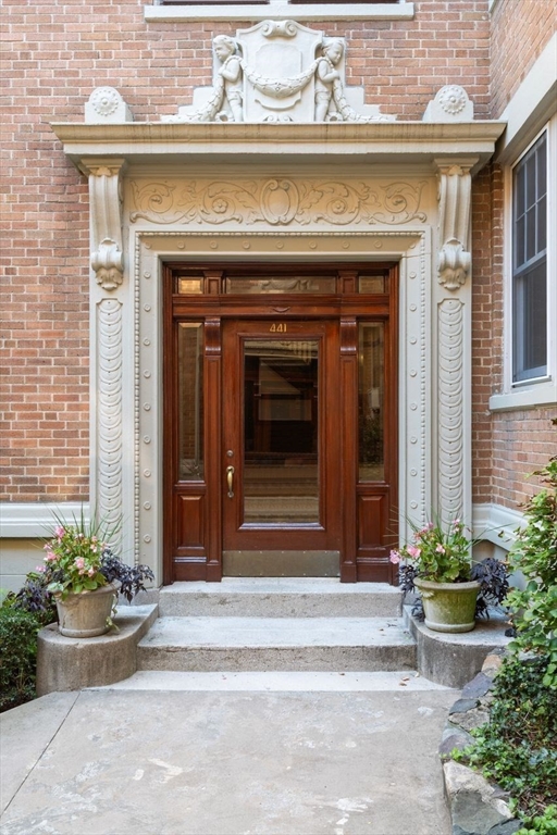 441 Washington Street, Unit 2 Brookline, MA 02446 - Photo 2 of 28 a front view of a house with potted plants