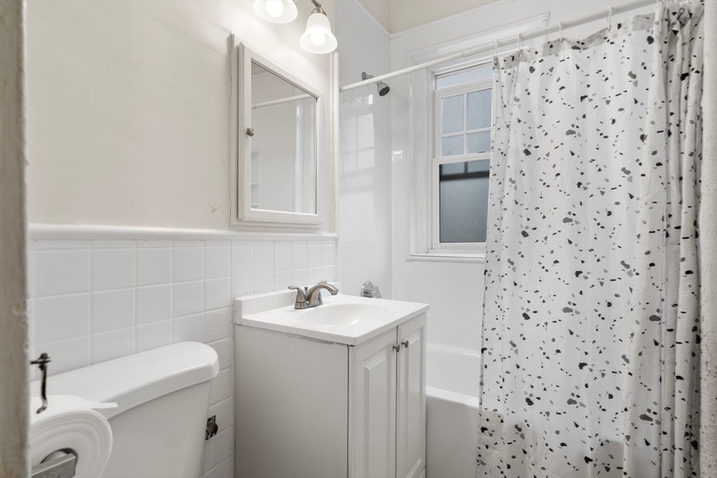 441 Washington Street, Unit 2 Brookline, MA 02446 - Photo 24 of 28 a bathroom with a sink a toilet and shower