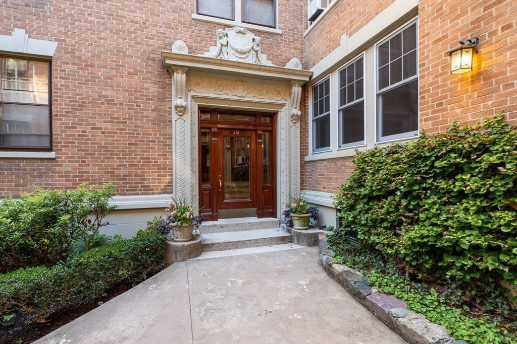 441 Washington Street, Unit 2 Brookline, MA 02446 - Photo 6 of 28 a front view of a house with a yard