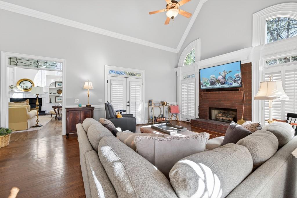2761 Calloway Court Duluth, GA 30097 - Photo 29 of 124 a living room with furniture a fireplace and a large mirror