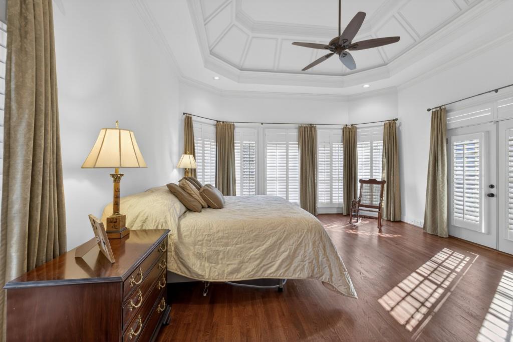 2761 Calloway Court Duluth, GA 30097 - Photo 38 of 124 a bedroom with a bed and a lamp on table with wooden floor
