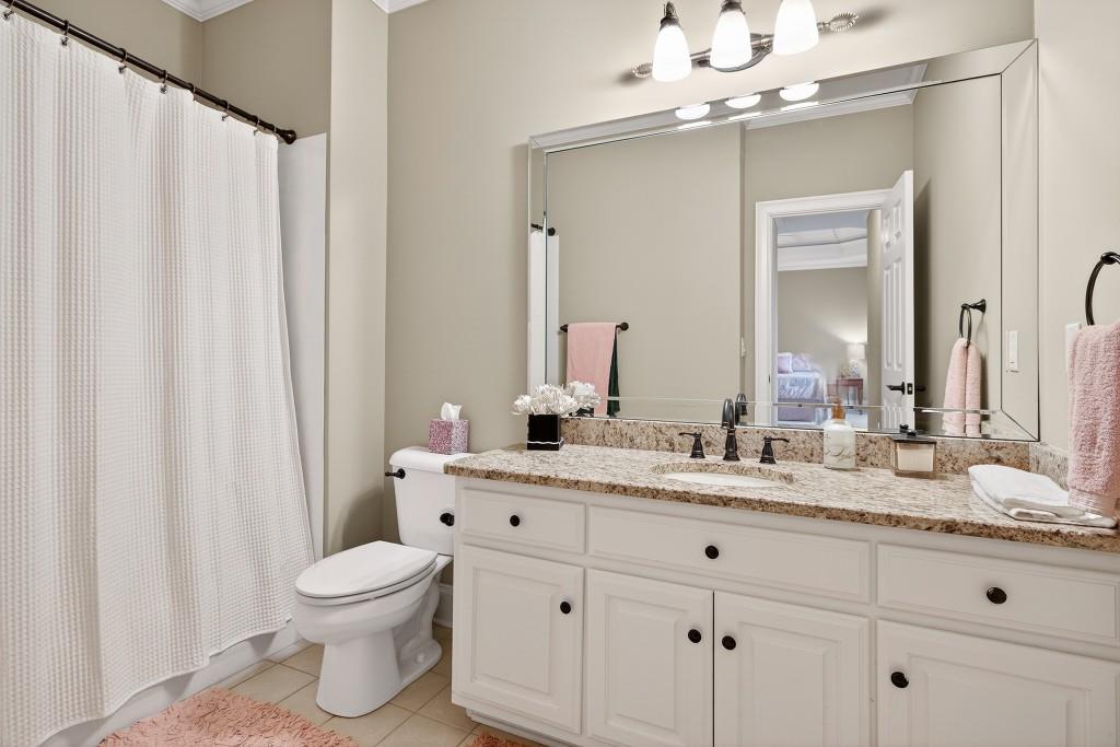 2761 Calloway Court Duluth, GA 30097 - Photo 56 of 124 a bathroom with a granite countertop sink toilet and mirror