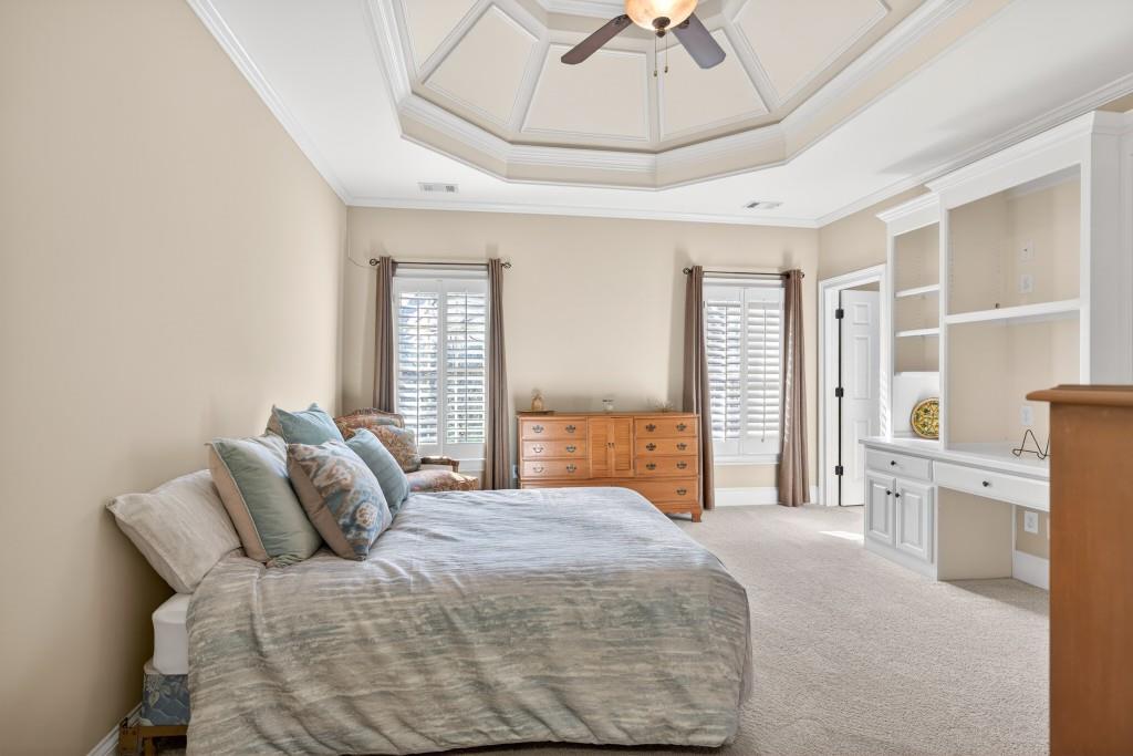 2761 Calloway Court Duluth, GA 30097 - Photo 59 of 124 a bedroom with a large bed and a chandelier