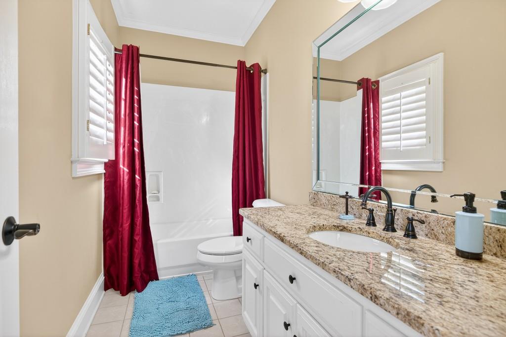2761 Calloway Court Duluth, GA 30097 - Photo 60 of 124 a bathroom with a granite countertop sink a toilet and a shower