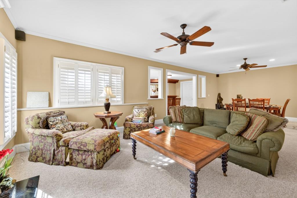2761 Calloway Court Duluth, GA 30097 - Photo 69 of 124 a living room with furniture ceiling fan and a window