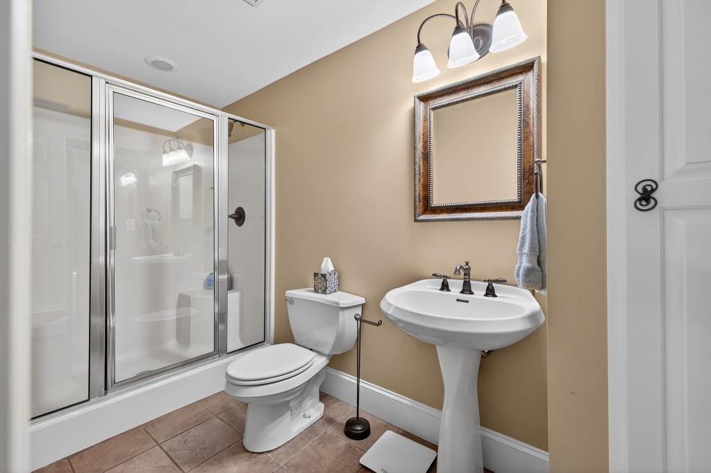 2761 Calloway Court Duluth, GA 30097 - Photo 78 of 124 a bathroom with a sink mirror toilet and shower