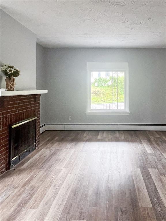 49 North Linwood Avenue Pittsburgh, PA 15205 - Photo 5 of 17 an empty room with wooden floor fireplace and windows