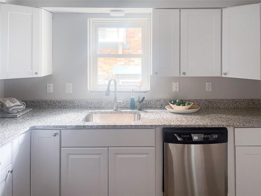 49 North Linwood Avenue Pittsburgh, PA 15205 - Photo 7 of 17 a kitchen with granite countertop a sink and a white cabinets