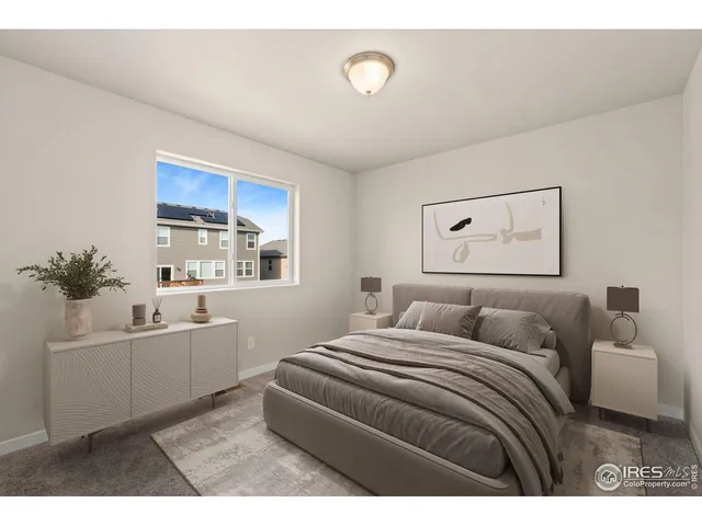 a bedroom with a white bed and white cabinets