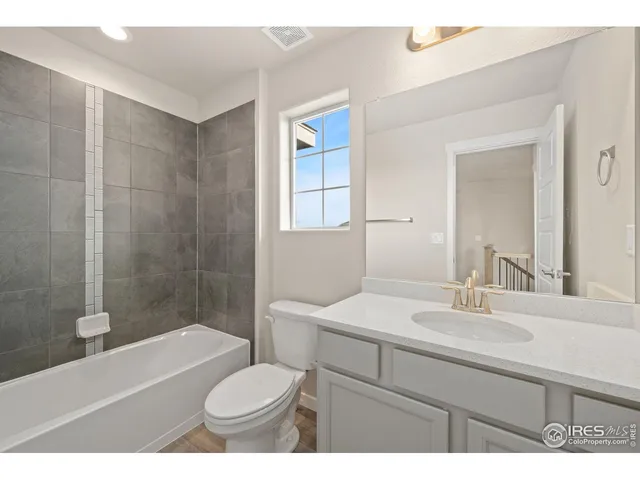 a bathroom with a sink toilet a mirror and shower