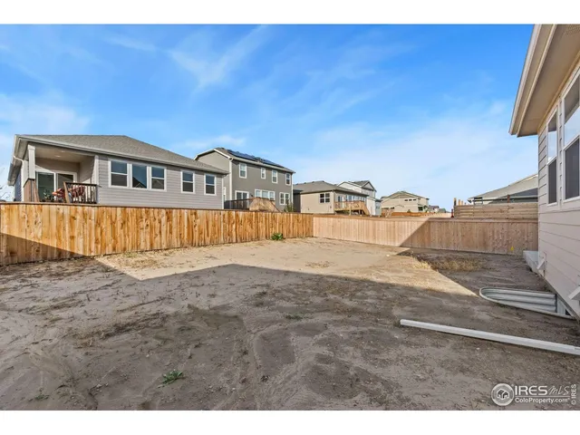a view of a house with a wooden fence