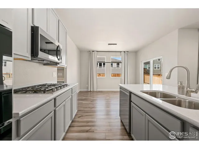 a kitchen with stainless steel appliances granite countertop a sink stove and microwave