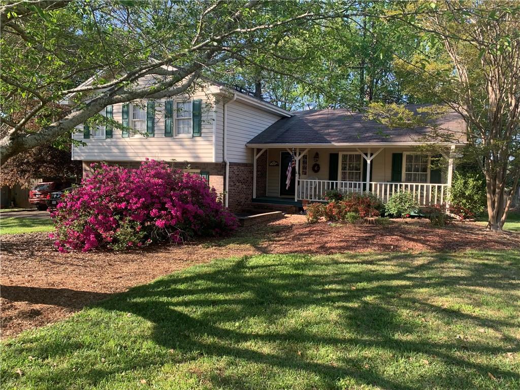 224 Abri Place Southwest Lilburn, GA 30047 - Photo 1 of 19 a front view of a house with a garden