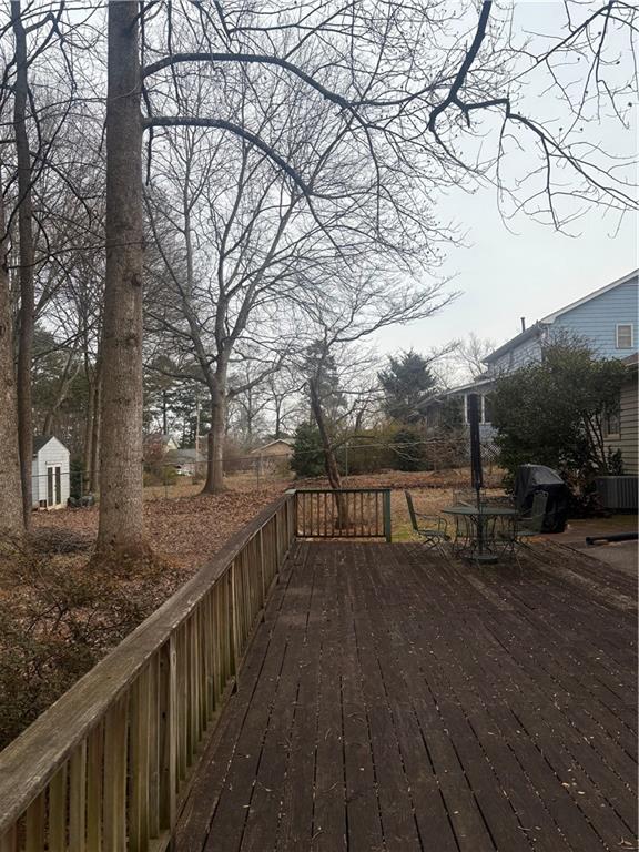 224 Abri Place Southwest Lilburn, GA 30047 - Photo 18 of 19 a view of a house with wooden deck next to a road