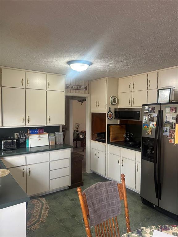 224 Abri Place Southwest Lilburn, GA 30047 - Photo 6 of 19 a kitchen with stainless steel appliances kitchen island granite countertop a sink and cabinets