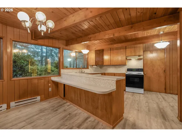 a view of kitchen with cabinets and wooden floor