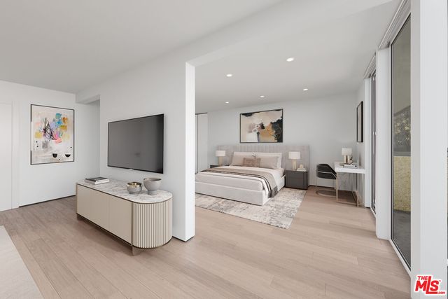 a living room with furniture a flat screen tv and a couch