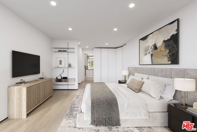 a hotel room with a bed and a flat screen television