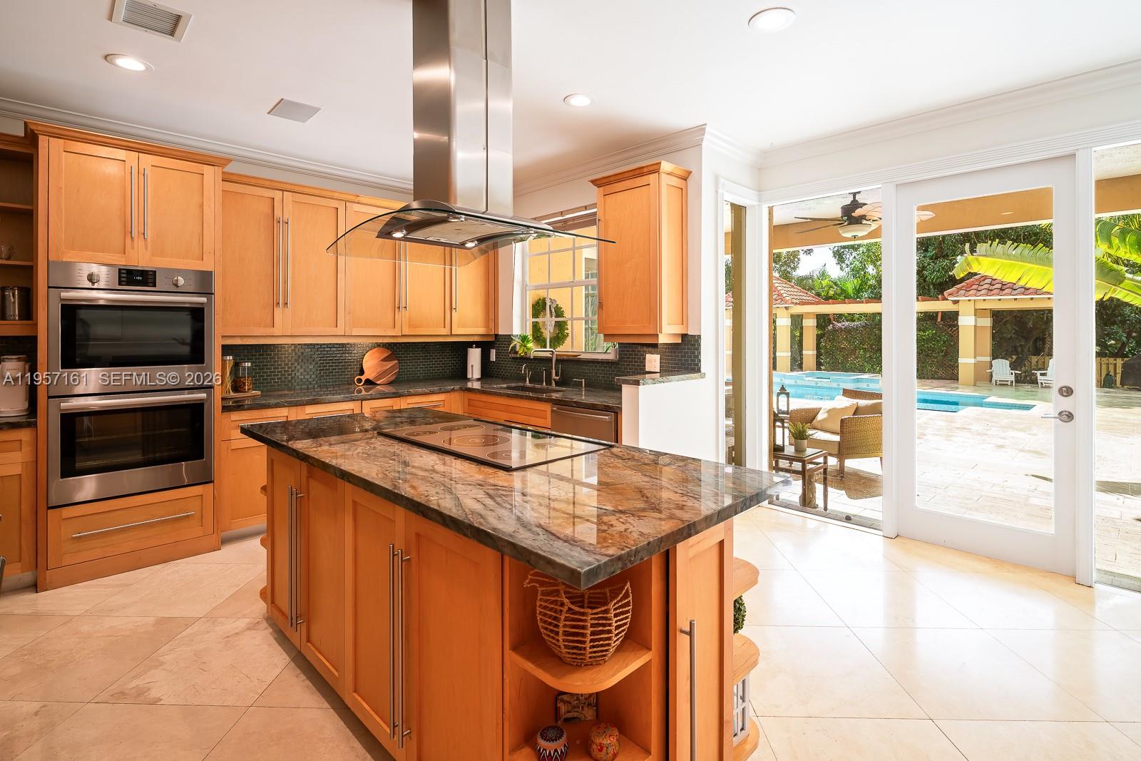 5770 Southwest 128th Street Pinecrest, FL 33156 - Photo 18 of 37 a kitchen with stainless steel appliances granite countertop a stove a sink and a microwave