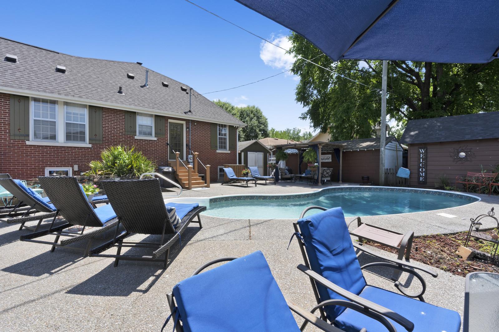 403 North Garner Street Springfield, TN 37172 - Photo 4 of 29 a view of a patio with table and chairs under an umbrella