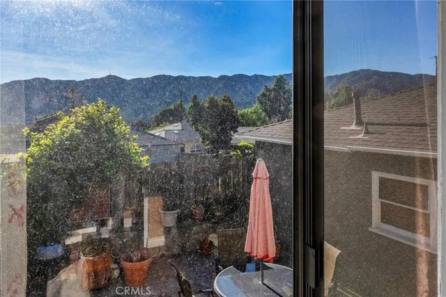 a view of a balcony with a table and chairs
